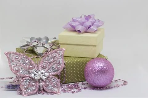 Two gift boxes, a butterfly and a ball on a white background Foto stock