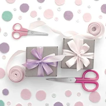 Two gift boxes on festive pastel confetti background. Stock Photos