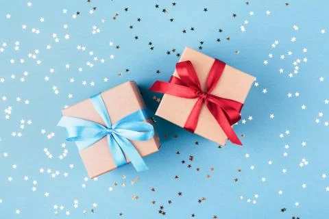 Two gift boxes wrapped in kraft paper with confetti. Stock Photos