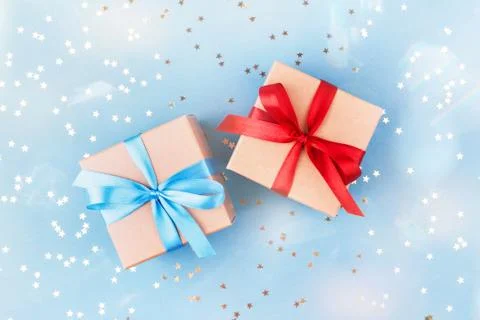 Two gift boxes wrapped in kraft paper with confetti. Stock Photos
