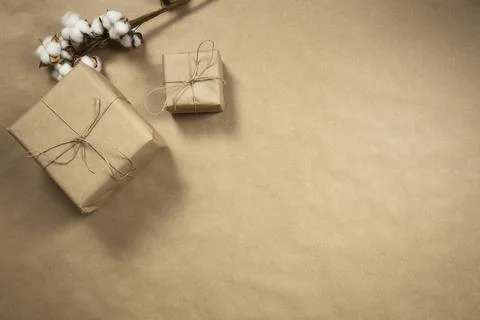 Two gift boxes wrapped in plain brown recycled paper with rope on brown Stock Photos