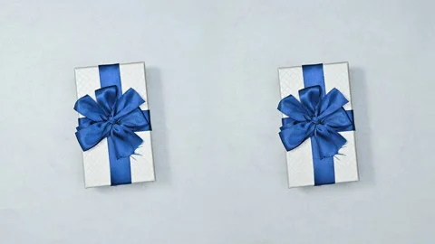 Two gifts rotating and changing on silver theme. Stop motion Stock Footage 166246794