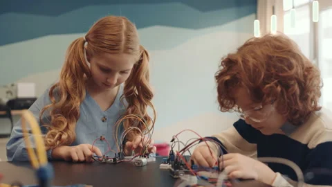 Two Ginger Kids Constructing Robots in School Video stock 153463577