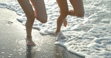 Two girlfriends are actively running along the coast. The close-up view of the Stock Footage 85508330