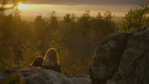 Two girlfriends are looking on the sunset Stock Footage 91187926