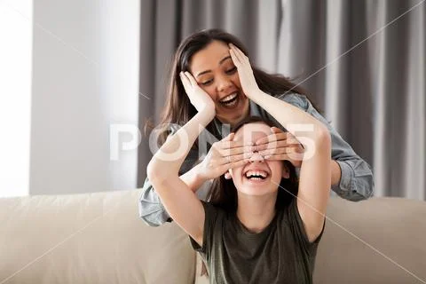 Two girlfriends are playing hide and seek Stock Photos
