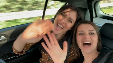 Two girlfriends in car smiling taking selfie video Stock Footage 118645135