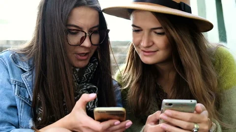 Two girlfriends doing online shopping in the park. Stock Footage 85894248