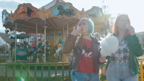 Two girlfriends eating cotton candy Stock Footage 99623733