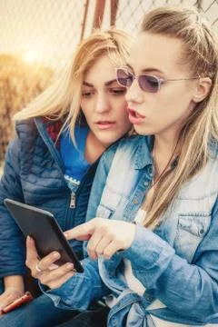 Two girlfriends having fun with digital tablet Stock-Fotos