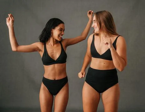 Two girlfriends having loads of fun dancing in the studio Stock Photos