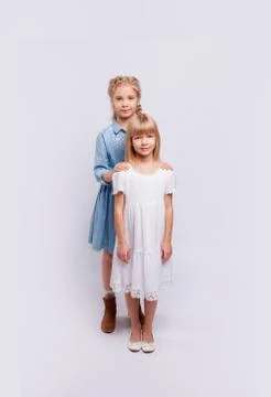 Two girlfriends or sisters with the same hair color are hugging. Stock Photos