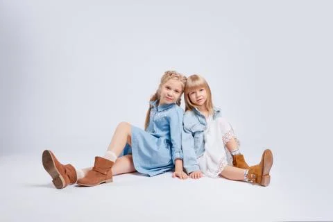 Two girlfriends or sisters with the same hair color are hugging. Stock Photos