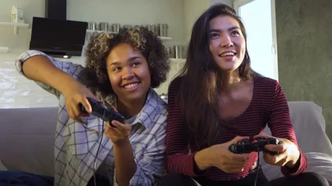 Two girlfriends play with joysticks Video stock 165836849