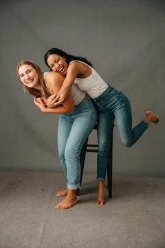 Two girlfriends playing round and having fun bare foot Stock Photos