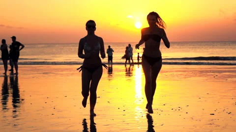 Two girlfriends running on beach, during sunset, super slow motion Stock-Footage 68538237