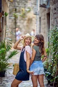 Two girlfriends on strret making funny face expressions, having fun togethe.. Stock Photos