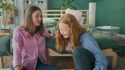 Two Girlfriends, Students at Home Talking Gossip, Have Fun Smiling while Sitting Stock Footage 219592218