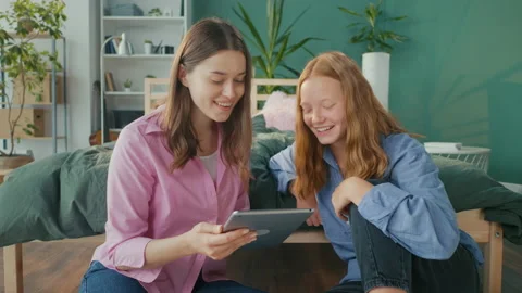 Two Girlfriends, Students at Home Talking, Gossip, Have Fun, Check Social Media Stock Footage 219592315