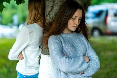 Two girlfriends in the summer in a park in nature. Offended each other. Friends Stock Photos