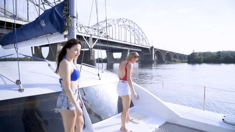 Two girls are dancing on a yacht Stock Footage 91393653