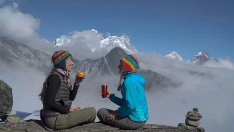 Two girls are drinking tea in the mountains Stock Footage 84829327