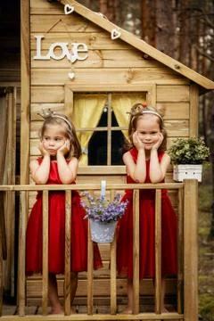 Two girls are posing in a tree house Stock Photos