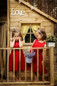 Two girls are posing in a tree house Stock Photos