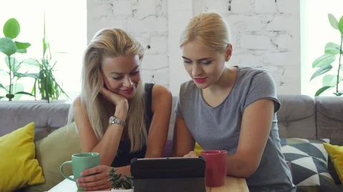 Two girls are watching something on the tablet Stock Footage 80471743