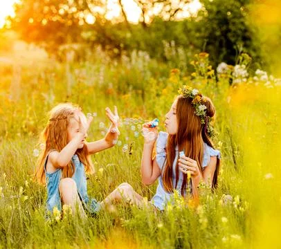 Two Girls Blowing Bubbles Stock Photos