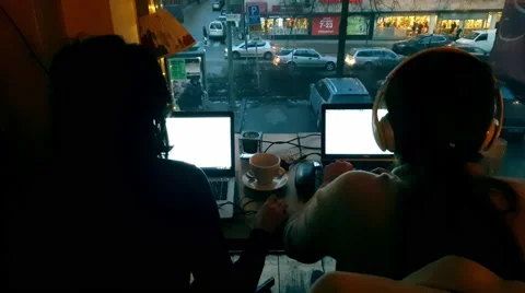 Two Girls checking email working with laptop in a coffee shop -street background Stock Footage 61350103