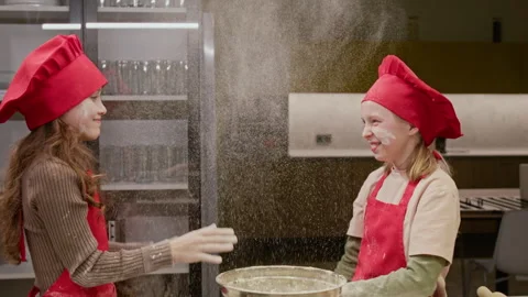 Two Girls Clapping Hands with Flour Having Fun Baking Together Stock Footage 339504500