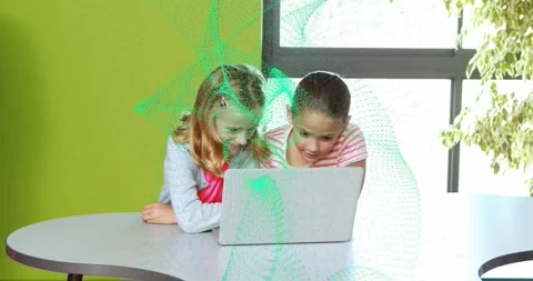 Two girls collaborating on laptop in class, teacher leaving and green particles Stock Footage 330142755
