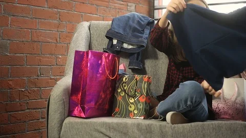 Two girls on the couch considering packages with shopping Stock Footage 103456109