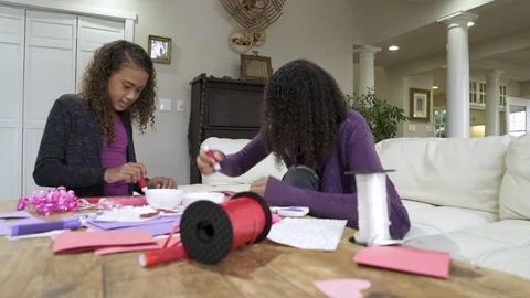 Two girls craft making together at table. Stock Footage 88174936