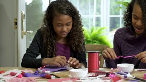 Two girls craft making together at table. Stock Footage 88183160