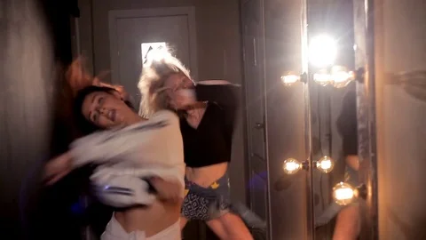 Two girls dance in the dressing room before a performance in a nightclub Stock Footage 80844525