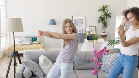 Two girls dance in light room Stock Footage 89791817