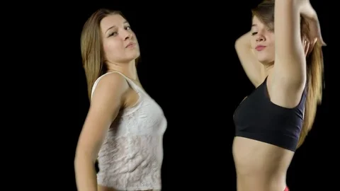 Two girls dancing on a green background Video stock 72211836