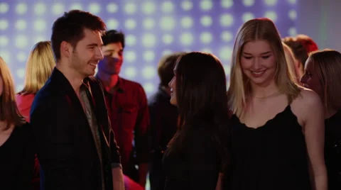 Two girls dancing with  one guy at club Stock Footage 61650350