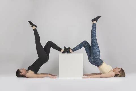 Two girls doing gluteus exercise Stock Photos