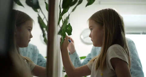 Two Girls Drawing Easter Decorations on White Wall Together Stock Footage 297699860