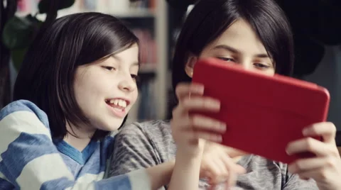 Two girls fighting while using a digital tablet at home Stock Footage 63861679