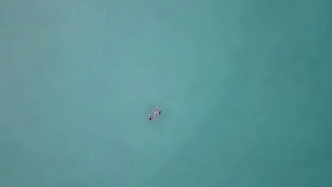 Two Girls Floating in Sea. Aerial View Stock Footage