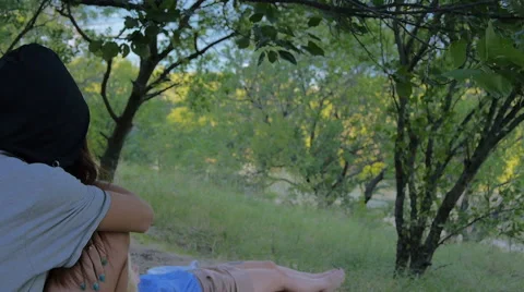 Two girls in a forest when one girl fall asleep and another one wathc for her Video stock 68701445