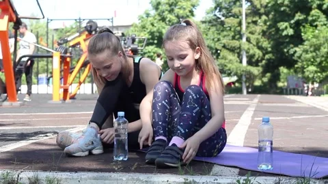 Two girls get ready to play sports Stock Footage 132949185