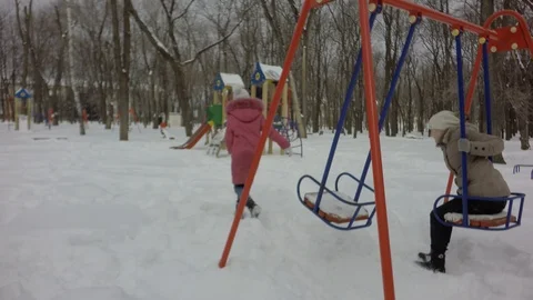 Two girls got up from the swing and ran to the children's hill. Video stock 87740407