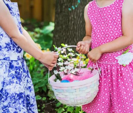 Two Girls Hands Holding an Easter Basket Stock Photos