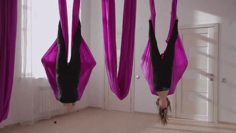 Two girls hang upside down 2 Stock Footage