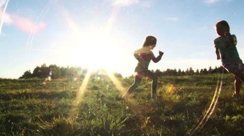 Two girls having fun running in the sunset Stock Footage 53749389